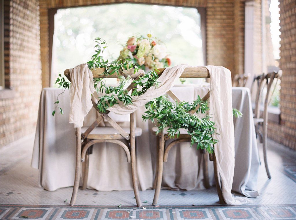 Greenery and Silk Draping on Wedding Chairs