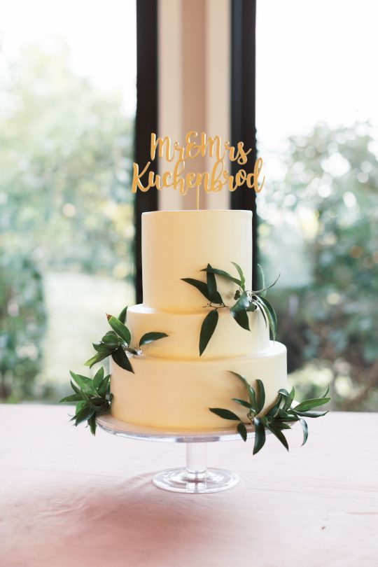 Ivory Three Tiered Wedding Cake with Greenery